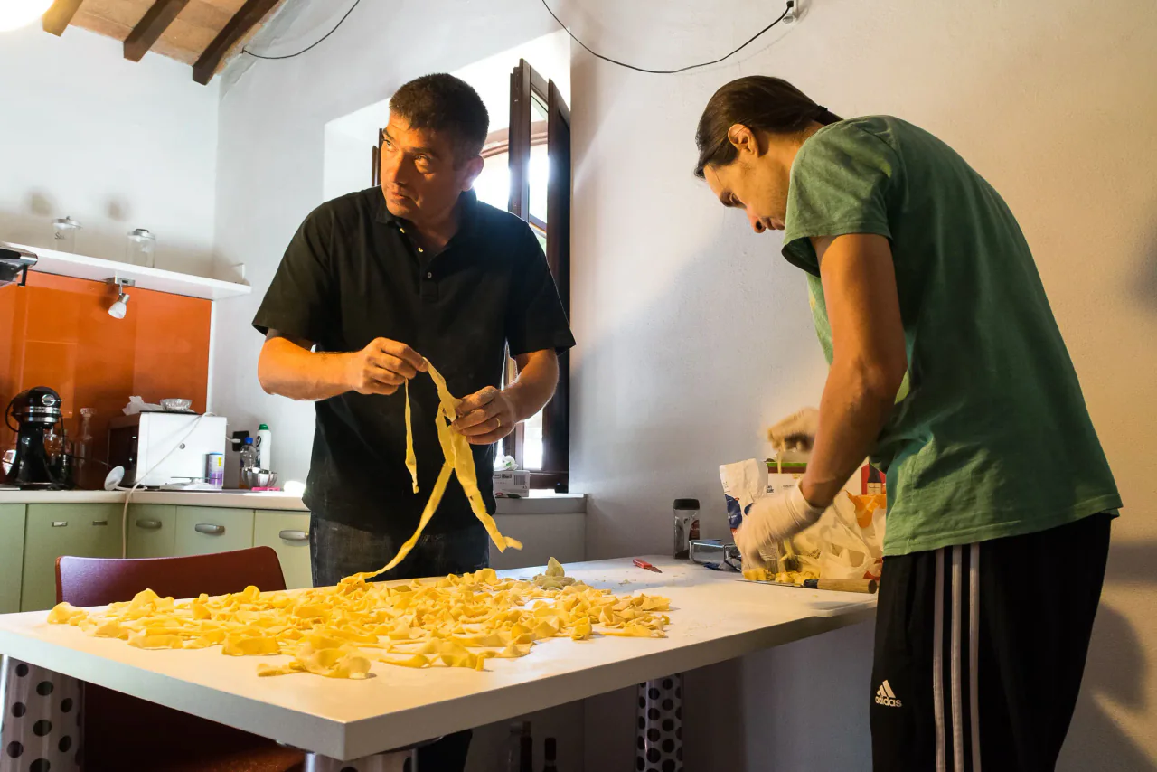 Due persone preparano insieme la pasta fresca.